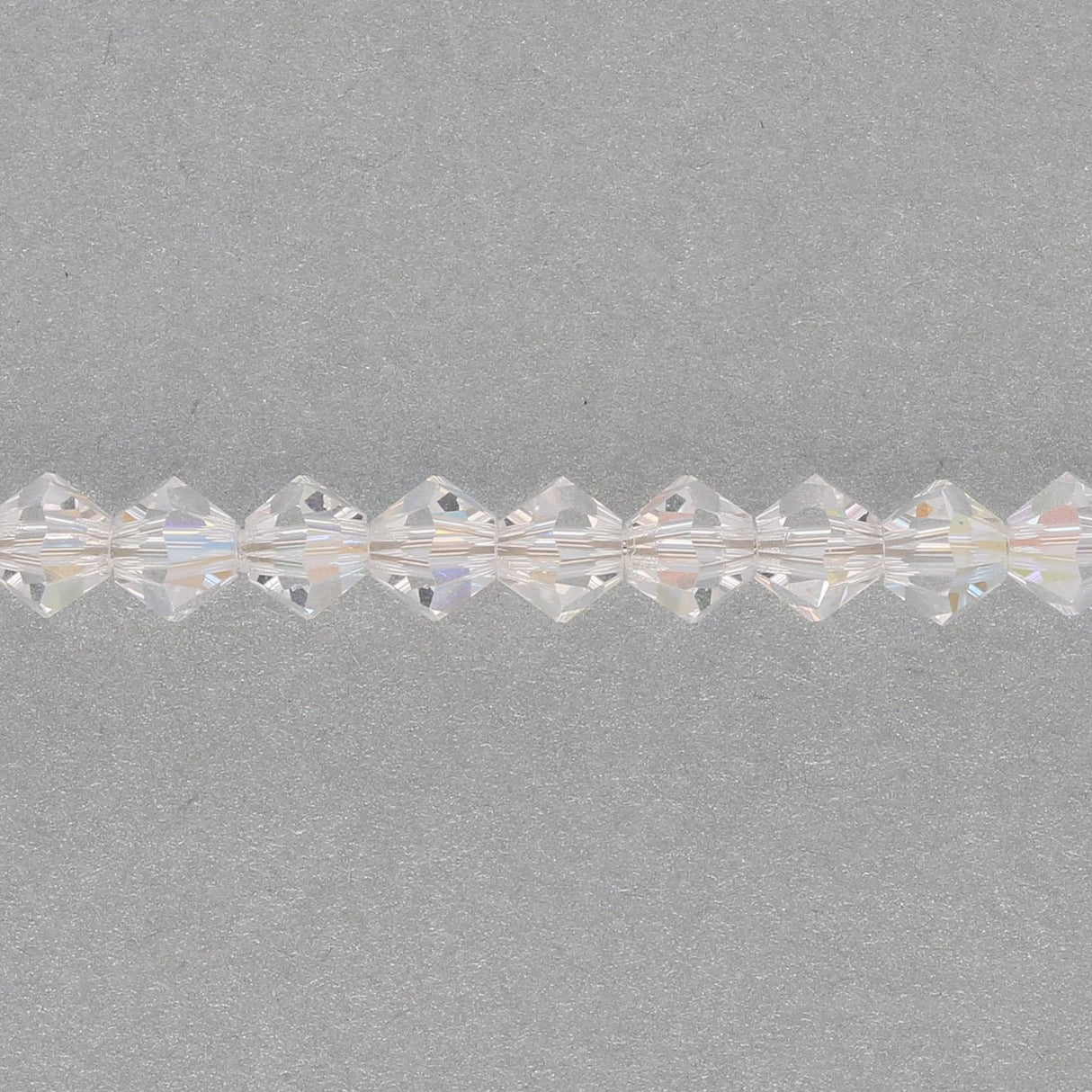 M.C. Doppelkegel 4 mm - Crystal AB - PerlineBeads SA