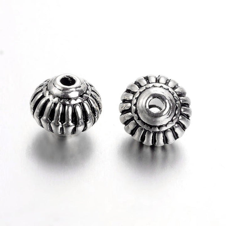 Metallperle im tibetischen Stil 8 x 6,5 mm - Antiksilber - PerlineBeads