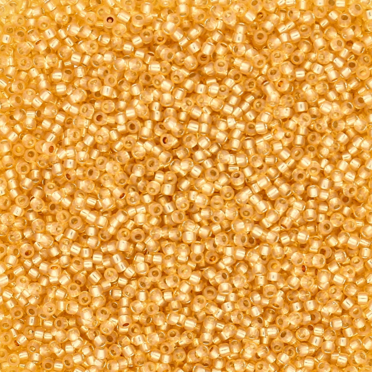 Rocailles-Perlen Toho 15/0 – Silver-Lined Milky Light Topaz - PerlineBeads